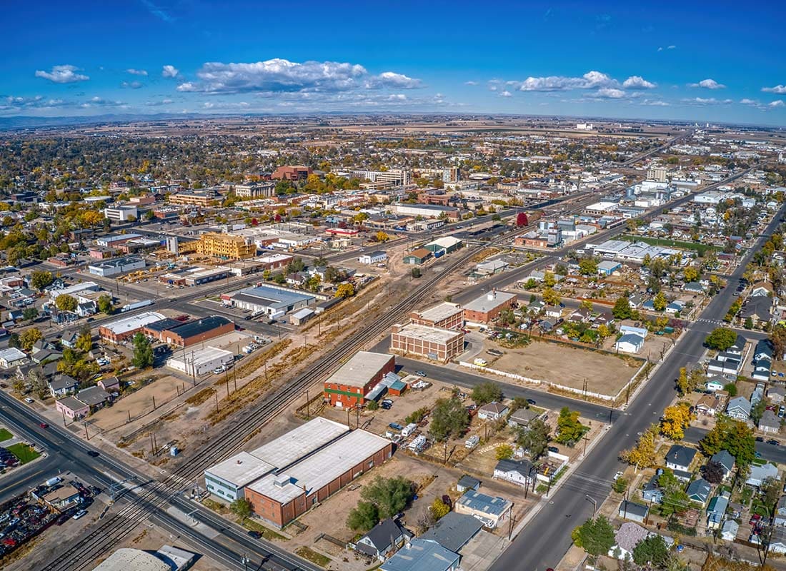Greeley, CO - Aerial View of Buildings and Homes in Downtown Greeley Colorado on a Sunny Day